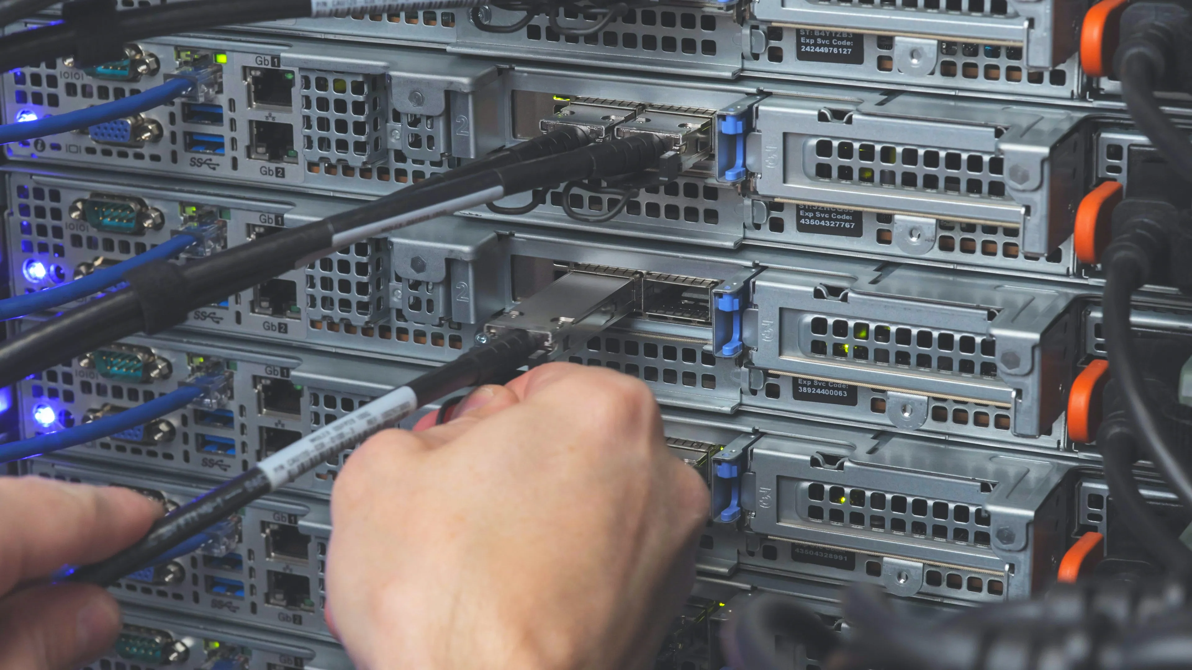 Close-up of a SFP transceiver being inserted into a server — high-speed connectivity at the heart of modern data centres.