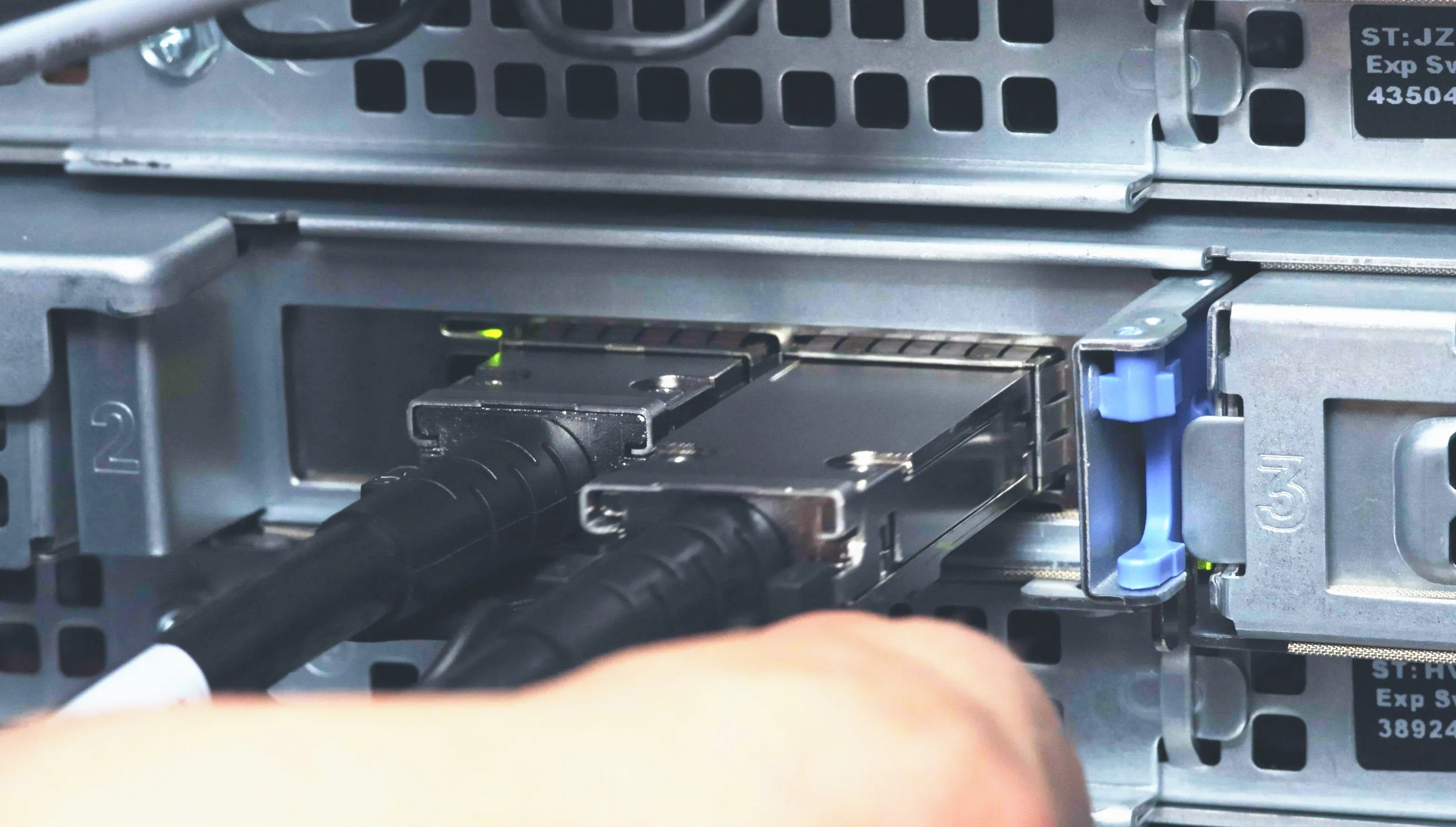 Close-up of DAC cables plugged into rack-mounted storage units — the physical layer your storage strategy depends on.