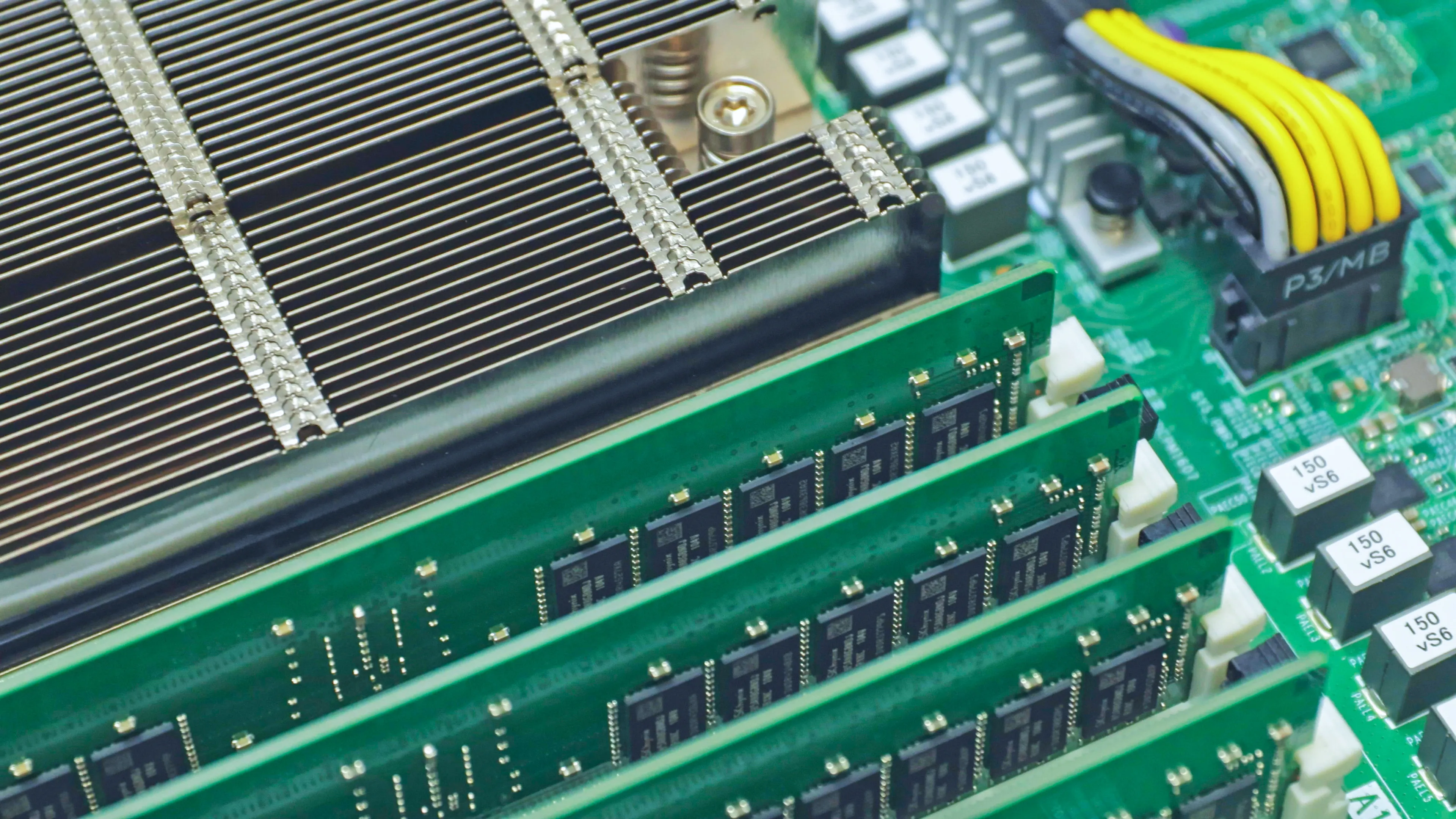 Close-up of server CPU heatsink and RAM modules — high-density compute hardware inside a rack-mounted server.