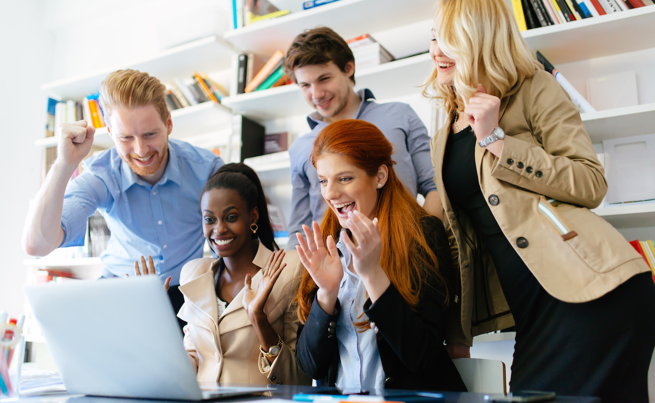 Succesful company celebrates business success with coworkers being happy